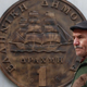 A man passes in front of a huge replica of a one drachma coin in Athens in 2011.